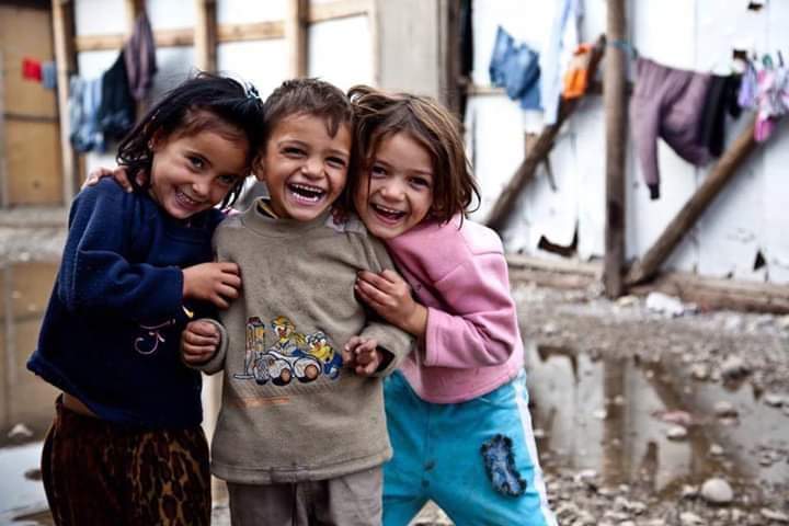 A mother and daughter smiling after receiving aid